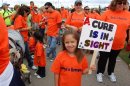 Gavin's cousin Maya holding A Cure is in Sight sign.